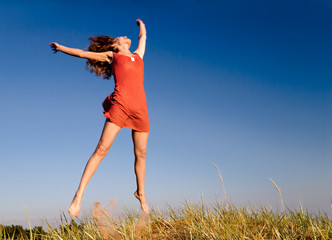 girl jumping on a dune-1