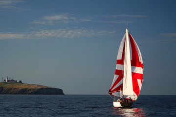 yacht on sunrise near island