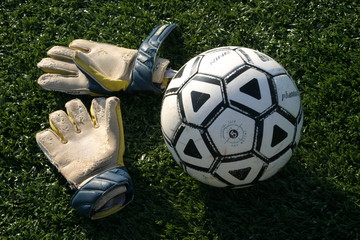 goalie gloves with soccer ball.