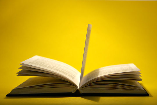 Open Book On Yellow