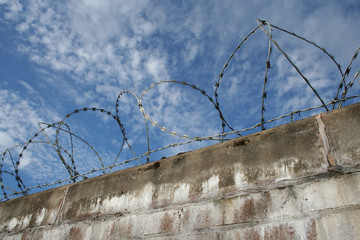 brick wall with barbed wire