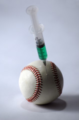 baseball and syringe on a light background