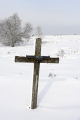 catholic cross on a snowy meadow