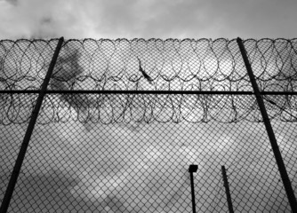 forbidding razor wire prison fence