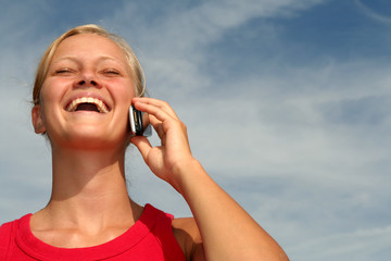 happy young woman using a mobile phone