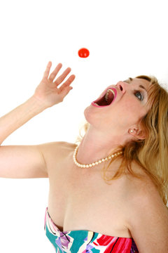 Woman Catching Cherry Tomato In Mouth