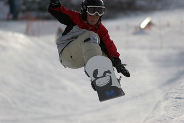 Fototapeta na wymiar snowboarder jumping and grabbing his board