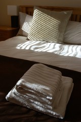 freshly made bed in a smart hotel room