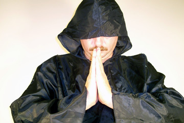 man with mustache preying
