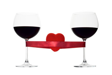two wine glasses tied with a red heart