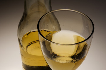 glass of white wine and bottle