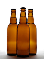 three beer bottles in backlight