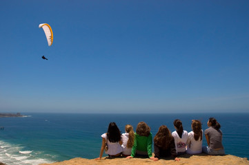 girls watching parachuter