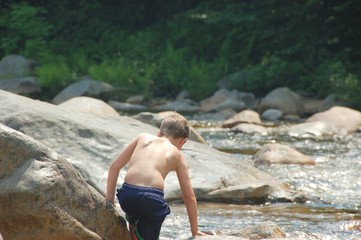 boy playing on the rocks