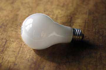lightbulb with shadow on wood