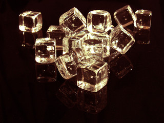 gold ice cubes in black background