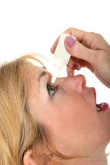 woman using eye drops