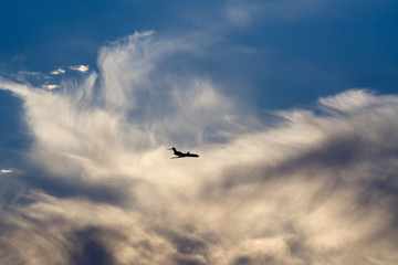 air-liner in evening cloudy sky
