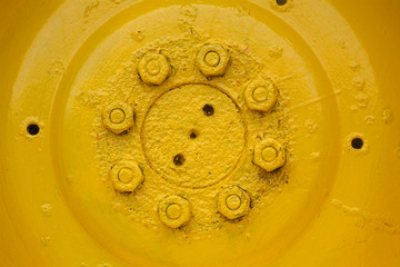 detail of old, yellow wheel