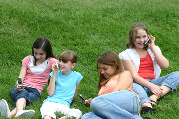 Fototapeta premium group of girls using cell phones