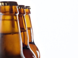 upper part of three beer bottles