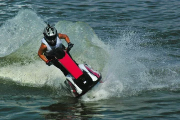 Wall murals Water Motor sports riding a jetski in water drops