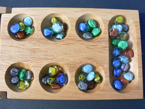 Mancala Stones On Board Stock Photo - Download Image Now - Marbles