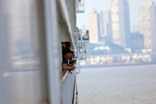 people looking at the city from a cruise ship