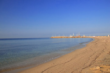 empty beach and a pier