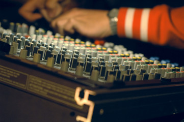 musician mixing on audio board
