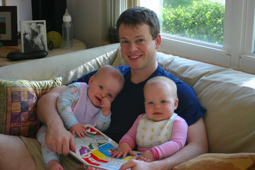 young father reading to twins