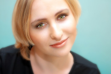 face of young blond woman with green eyes