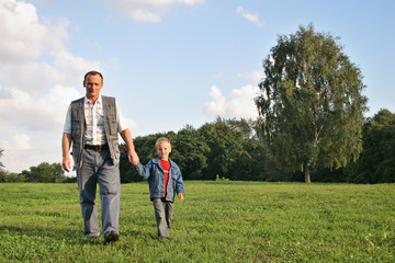 Fototapeta na wymiar grandfather and boy walking