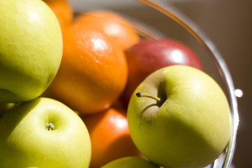 fruit bowl full of fresh apples and oranges