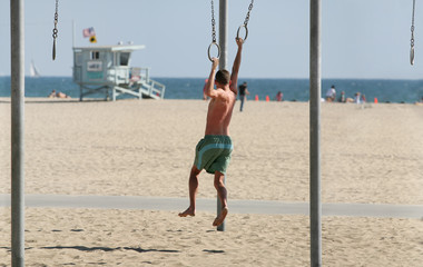 teen exercising on beach