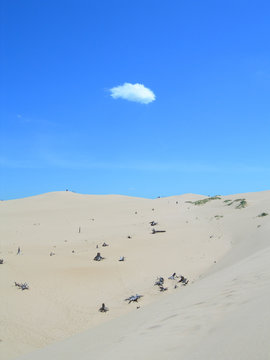 lonely cloud over sand dunes