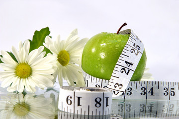 apple, flowers and measurement tape