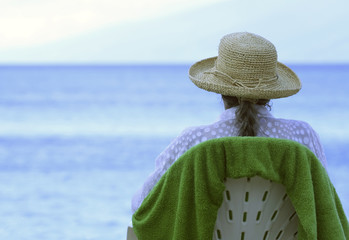 senior woman sitting on beach