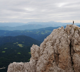 man on high peak in the dolomites,italy