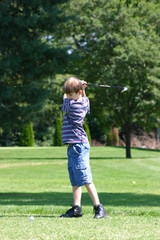 Fototapeta premium boy swinging golfclub
