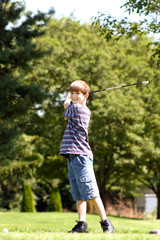 boy smiling while golfing