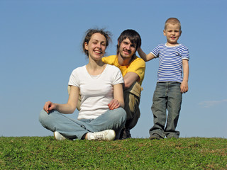 family on grass sit