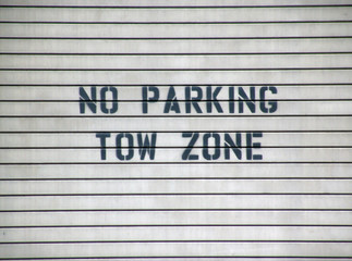 no parking tow zone sign
