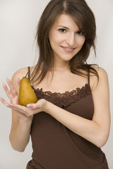 girl posing holding pear