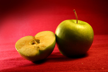 deluxe green apples on red background