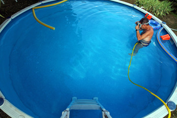 man cleaning swimmimg pool