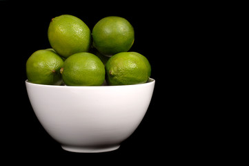 limes in white bowl