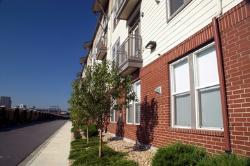 sidewalk along street with apartments