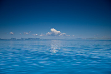 view of an open sea with a cloud on corfu island