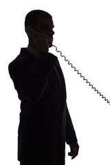silhouette of man talking phone